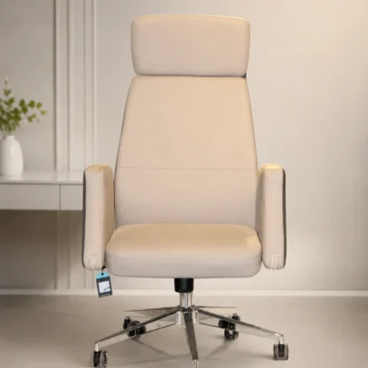 Premium High Back Leather Executive Office Chair for Luxury Workspaces The Premium High Back Leather Executive Office Chair is designed for professionals who demand exceptional comfort, sophisticated style, and reliable performance. Featuring a modern executive design with premium leatherette upholstery, this chair creates a luxurious seating experience while enhancing the appearance of executive cabins, corporate offices, boardrooms, and home workspaces. Its elegant high-back profile is carefully engineered to provide full support for the neck, shoulders, and back, promoting healthy posture throughout long working hours. The ergonomically contoured backrest follows the natural curve of the spine, helping reduce pressure on the lower back while improving overall sitting comfort. The generously padded seat is crafted with high-density cushioning that offers superior comfort and maintains its shape over extended use. Whether you are attending virtual meetings, managing daily operations, or working on important projects, this executive office chair delivers consistent support from morning to evening. Wrapped in premium-quality leatherette upholstery, the chair offers a refined finish that is soft to the touch, easy to maintain, and resistant to everyday wear. The elegant cream color complements modern office interiors, adding a clean, premium, and professional aesthetic to executive spaces. Designed for smooth mobility, the chair features a heavy-duty chrome base equipped with durable caster wheels that glide effortlessly across various flooring surfaces. The 360-degree swivel mechanism allows easy movement in every direction, improving efficiency and flexibility in fast-paced work environments. The fixed padded armrests provide additional comfort by supporting the arms and shoulders, helping reduce fatigue during extended periods of computer work, meetings, or administrative tasks. The sturdy frame and premium construction ensure long-lasting durability, making this chair suitable for daily commercial and professional use. Ideal for CEOs, directors, senior managers, consultants, architects, entrepreneurs, and business professionals, this executive chair combines luxury, comfort, and functionality in one elegant seating solution. It seamlessly fits into executive cabins, conference rooms, luxury offices, premium coworking spaces, and modern home offices. Manufactured with high-quality materials and precision craftsmanship, the Premium High Back Leather Executive Office Chair is built to deliver outstanding durability, ergonomic support, and timeless style. It is an excellent investment for businesses looking to create a productive, comfortable, and sophisticated working environment. Upgrade your office with a chair that reflects professionalism, confidence, and premium quality while providing exceptional comfort for everyday use. Key Features Premium High Back Executive Design Ergonomic Lumbar & Back Support Premium Leatherette Upholstery Elegant Cream Finish High-Density Foam Cushion Soft Padded Armrests Heavy-Duty Chrome Base Smooth 360° Swivel Rotation Durable Twin-Wheel Castors Commercial Grade Construction Comfortable for Extended Sitting Easy to Clean and Maintain SEO Keywords Executive Office Chair High Back Office Chair Leather Executive Chair Premium Office Chair Luxury Office Chair Boss Chair CEO Office Chair Director Chair High Back Leather Chair Revolving Office Chair Swivel Office Chair Ergonomic Executive Chair Corporate Office Chair Premium Office Furniture Modern Executive Chair