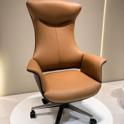 Experience unmatched executive comfort with the Luxury Ergonomic Executive Boss Chair, a premium seating solution designed for senior professionals who demand superior support, sophisticated aesthetics, and long-lasting performance. Featuring an elegant extra-high backrest with a sculpted ergonomic profile, this chair delivers exceptional support to the neck, shoulders, and spine during extended working hours. The generously cushioned seat and backrest are upholstered in premium-quality material that offers a soft, luxurious feel while enhancing the visual appeal of executive interiors. The integrated ergonomic headrest provides enhanced neck comfort, while the wide padded armrests support relaxed arm positioning and reduce shoulder fatigue. Built for professional performance, this executive chair includes a smooth height-adjustable mechanism, 360-degree swivel functionality, and durable caster wheels for effortless mobility. The designer metal base ensures excellent stability, strength, and long-term durability, making it suitable for daily commercial office use. Its bold contemporary design and luxury finish make this chair an outstanding choice for executive cabins, CEO offices, director rooms, boardrooms, premium workstations, and luxury home offices. Key Features Extra-high ergonomic executive backrest Sculpted integrated headrest for neck support Premium upholstered cushioning Wide padded armrests for superior comfort Thick seat cushioning for long working hours 360° swivel functionality Height-adjustable seating mechanism Designer heavy-duty metal base Smooth rolling caster wheels Strong and stable construction for executive use Ideal For CEO offices Director rooms Executive cabins Corporate offices Boardrooms Premium workstations Luxury home offices SEO Keywords Luxury executive chair, boss chair, ergonomic executive office chair, high back office chair, CEO chair, director office chair, premium office chair, luxury boss chair, executive swivel chair, upholstered executive chair, modern corporate office chair, designer office chair.