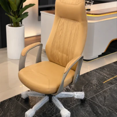 Elevate your office interior with the Premium Designer High Back Executive Office Chair, a perfect blend of luxury aesthetics, ergonomic comfort, and professional functionality. Crafted with premium upholstery and a refined contemporary design, this executive chair is ideal for directors, managers, consultants, and professionals who seek superior comfort and an impressive workspace appearance. The ergonomic high-back structure provides excellent support to the neck, shoulders, and lower back, helping maintain proper posture during long working hours. The generously padded seat and backrest ensure exceptional comfort throughout the day, while the integrated headrest area offers enhanced neck support. Featuring stylish designer armrests with premium finishing, a smooth height-adjustable mechanism, and a 360-degree swivel base with durable caster wheels, this chair allows effortless movement and flexibility in executive environments. The sturdy metal base provides excellent stability and long-term durability, making it suitable for daily professional use. With its sophisticated finish and modern executive styling, this chair is a perfect addition to executive cabins, corporate offices, boardrooms, premium workstations, and luxury home offices. Key Features Ergonomic high-back executive design Premium upholstered seat and backrest Integrated headrest support Designer armrests with premium finish Thick cushioning for long-hour comfort 360° swivel functionality Height-adjustable seating mechanism Durable metal base Smooth rolling caster wheels Strong and stable construction for daily office use Ideal For Executive cabins Director rooms CEO offices Manager cabins Corporate offices Boardrooms Premium workstations Luxury home offices SEO Keywords Executive office chair, designer office chair, high back executive chair, boss chair, luxury office chair, director office chair, ergonomic executive chair, manager chair, premium office chair, swivel office chair, cushioned office chair, modern executive seating.