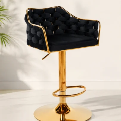 Add a statement of luxury to your interior with the Luxury Tufted Velvet Swivel Bar Chair with Gold Base, a premium seating solution crafted for sophisticated commercial and residential spaces. Featuring deep tufted velvet upholstery, elegant gold-finish metal detailing, and a contemporary swivel pedestal base, this chair combines exceptional comfort with high-end design. The generously cushioned seat and wraparound backrest provide superior support and a plush seating experience, while the integrated armrests enhance comfort during extended use. The smooth 360-degree swivel mechanism allows effortless movement, and the height-adjustable pedestal base enables customized seating for bars, kitchen counters, reception lounges, salons, cafes, and hospitality environments. Constructed with a durable metal frame and a stable round base, this luxury chair offers excellent strength, stability, and long-term performance. The built-in footrest adds ergonomic support and enhances overall seating comfort. With its striking black velvet upholstery and polished gold finish, this designer bar chair is perfect for upscale receptions, lounge areas, beauty salons, cafes, restaurants, hotel lounges, home bars, and premium kitchen islands. Key Features Luxury tufted velvet upholstery Elegant gold-finish metal frame 360° smooth swivel functionality Height-adjustable pedestal mechanism Comfortable wraparound backrest Integrated armrests for added support Built-in footrest for ergonomic comfort Stable heavy-duty round base Premium contemporary designer look Durable commercial-grade construction Ideal For Reception lounges Visitor waiting areas Hotel lounges Cafes and restaurants Home bars Kitchen islands Salon and beauty studios Premium hospitality spaces SEO Keywords Luxury bar chair, velvet swivel bar chair, gold base bar stool, tufted velvet chair, reception lounge chair, designer bar stool, adjustable bar chair, luxury reception chair, salon chair, cafe bar chair, hotel lounge chair, premium swivel stool.