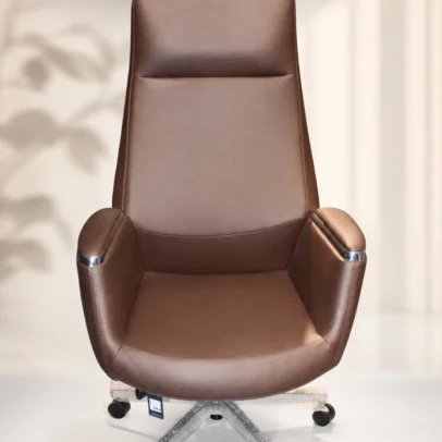 Luxury High Back Executive Boss Office Chair for Premium Office Interiors Enhance your workspace with the Luxury High Back Executive Boss Office Chair, a perfect blend of sophisticated design, superior comfort, and long-lasting durability. Designed for executives, directors, business owners, and professionals, this premium office chair adds elegance and functionality to any modern office environment. Crafted with a sleek high-back silhouette, this executive chair provides full upper-body support, helping maintain proper posture during long working hours. The generously cushioned backrest and spacious seat are designed to deliver exceptional comfort, reducing fatigue and promoting productivity throughout the day. Finished in premium brown leatherette upholstery, this chair brings a refined and luxurious appearance to executive cabins, boardrooms, conference rooms, and premium home offices. The rich brown finish complements contemporary office interiors while adding a professional and distinguished look to your workspace. The ergonomically designed structure supports the natural curve of the spine, providing excellent back and shoulder support for prolonged sitting. The wide seat and padded armrests enhance overall comfort, making it ideal for executives who spend extended hours attending meetings, managing teams, or working at a desk. Built with a heavy-duty metal base, the chair offers exceptional strength and stability for daily commercial use. Smooth-rolling caster wheels allow effortless movement across office floors, while the 360-degree swivel mechanism provides flexibility and convenience without interrupting workflow. The premium-quality upholstery is soft to the touch, durable, and easy to maintain, making it suitable for busy office environments. Precision stitching and clean lines highlight the chair's superior craftsmanship, ensuring it remains a stylish centerpiece in any executive office. Whether you're furnishing a corporate headquarters, director's cabin, luxury office, startup workspace, or home office, this chair offers the perfect combination of modern aesthetics and ergonomic performance. Its timeless design seamlessly integrates with executive desks, conference tables, and premium office furniture collections. Manufactured using high-quality materials, the Luxury High Back Executive Boss Office Chair is designed for reliability, durability, and everyday comfort. It is an excellent seating solution for professionals who value both style and performance in their workspace. Upgrade your office with a chair that reflects professionalism, authority, and premium quality. This executive chair is the ideal choice for creating a comfortable, productive, and elegant working environment. Key Features Premium High Back Executive Design Luxury Brown Leatherette Upholstery Ergonomic Back Support Spacious Cushioned Seat Soft Padded Armrests Heavy-Duty Metal Base 360° Smooth Swivel Mechanism Durable Twin-Wheel Castors Modern Executive Styling High-Density Foam Cushioning Strong Commercial-Grade Construction Easy to Clean & Maintain SEO Keywords Executive Office Chair Boss Office Chair High Back Executive Chair Brown Executive Chair Luxury Office Chair Premium Office Chair Leather Office Chair Director Office Chair CEO Chair Corporate Office Chair Swivel Office Chair Revolving Chair Office Furniture Executive Seating Modern Office Chair