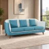 Modern blue three seater fabric sofa with wooden legs Blue contemporary sofa with three seat and back cushions Modern blue fabric sofa for home apartment and lounge Blue sofa with premium fabric finish and elegant edge detailing Modern three seater sofa from Global Star Furniture Ghaziabad