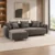 Modern sectional sofa design Integrated chaise / extended seating section Dark grey fabric upholstery Subtle textured upholstery appearance Spacious seating configuration Multiple layered cushions Button-detail cushion visible Rounded armrest design Clearly defined chaise construction Natural wood-toned tapered legs Contemporary residential appearance Suitable for living rooms and lounge areas