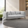Modern 3 seater sofa design Light grey fabric upholstery Soft fabric appearance Plush cushioning Multiple back cushions Individual seat cushions Refined edge detailing Sleek metal legs Contemporary silhouette Spacious seating arrangement Neutral colour suitable for modern interiors Designed for living rooms, lounges and modern homes