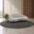 Modern curved upholstered sofa in light grey Contemporary curved sofa with sculptural backrest Light grey modern sofa with slim dark legs Curved living room sofa by Global Star Furniture Modern upholstered sofa manufacturer in Ghaziabad